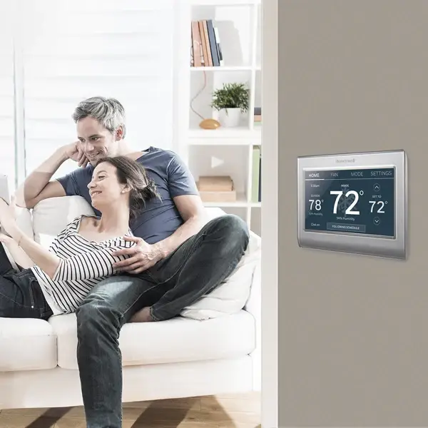 Smart Honeywell thermostat with touchscreen display, offering advanced temperature control and energy-saving features for modern homes.