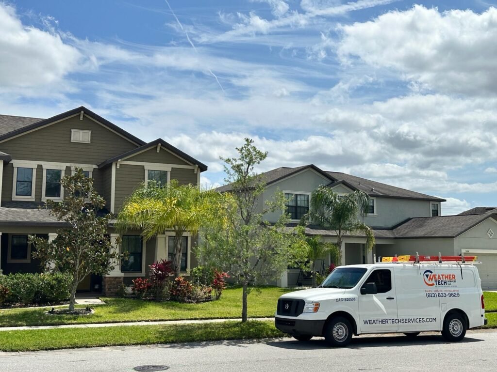 Weather Tech Services Company vehicle parked in front of a satisfied customer's home after providing emergency AC repair services